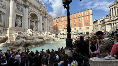 Crowds gather at Trevi Fountain in Rome.