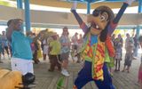 Goofy is in a celebratory mood with guests and crew on Disney's Lookout Cay at Lighthouse Point.