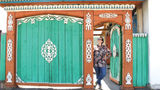 A traveler stands in a colorful doorway in Ulaanbaatar, the capital city of Mongolia, where the adventure travel company is launching a new rail itinerary in 2025.