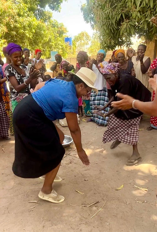 Nicole Edenedo motions her hand to sweep her feet during a welcome drum and dance circle.