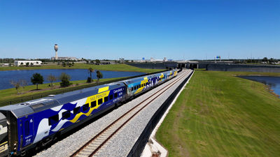 Brightline train cars adorned with Princess Cruises branding.