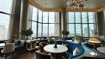 The dining room at Amar at the Raffles Boston, with views of the Back Bay area.