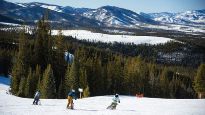 Ski bikers set off down the mountain during a run at Winter Park Resort in Colorado.