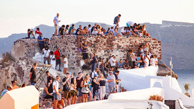 Visitors in Oia, Santorini, waiting to catch the sunset.