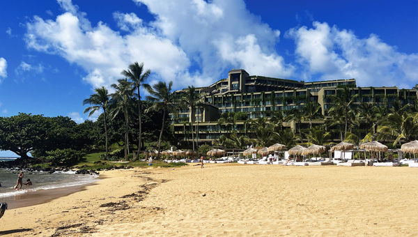 The view of the 1 Hotel Hanalei Bay from the resort's beach. The resort was repainted and covered with greenery, which helps it blend into the hillside.