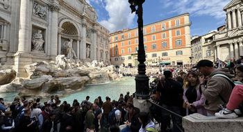 Hotel demand is very high in Italy. Pictured, a crowd around the Trevi Fountain in Rome.