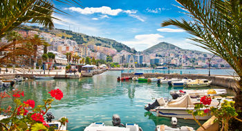 Travelers are opting for less expensive Europe destinations such as Albania. Pictured, the Albanian port city Saranda.